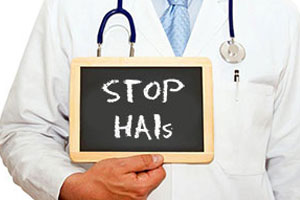 Picture of a Doctor holding a chalkboard that says Stop HAIs