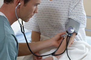 Doctor takes patient's blood pressure
